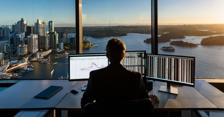 Analyst looking out to Sydney Harbour from office