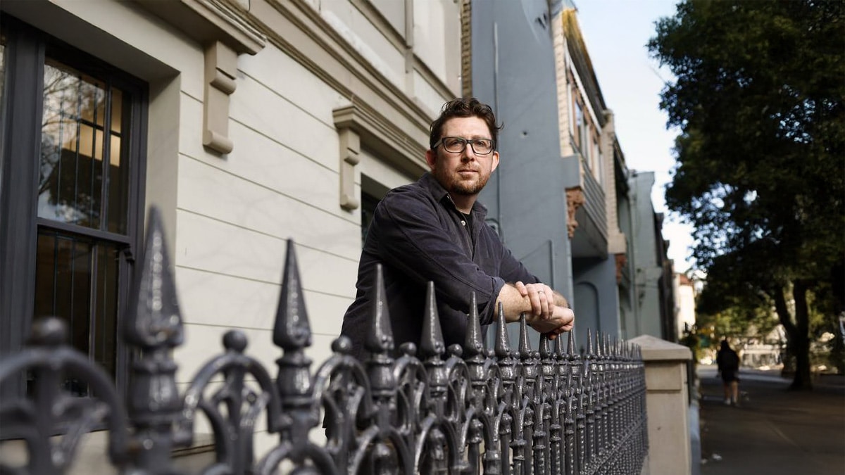 Australian tenant leaning on terrace fence