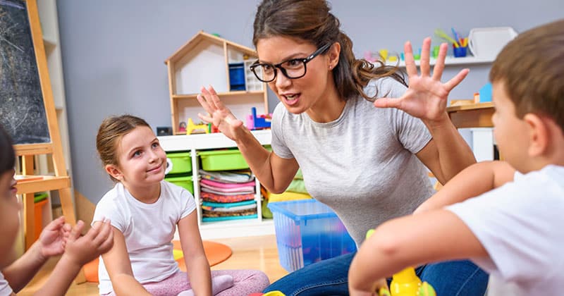 Educator interacting with young children in a playcentre or preschool