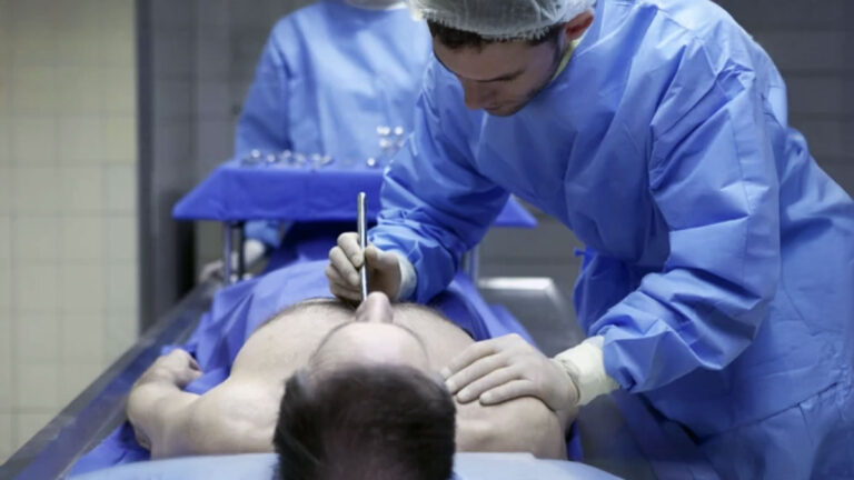 Forensic pathologist with fake body