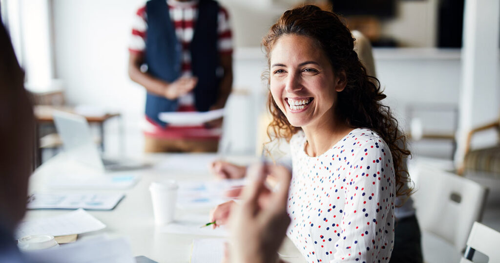 Woman with wide smile in meeting room