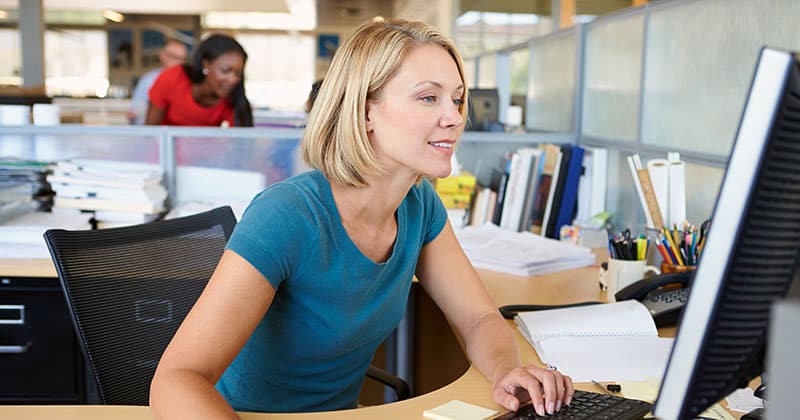 Woman working at her desk in an open plan office