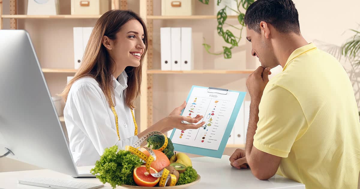 Nutritionist or dietitian consulting with a client