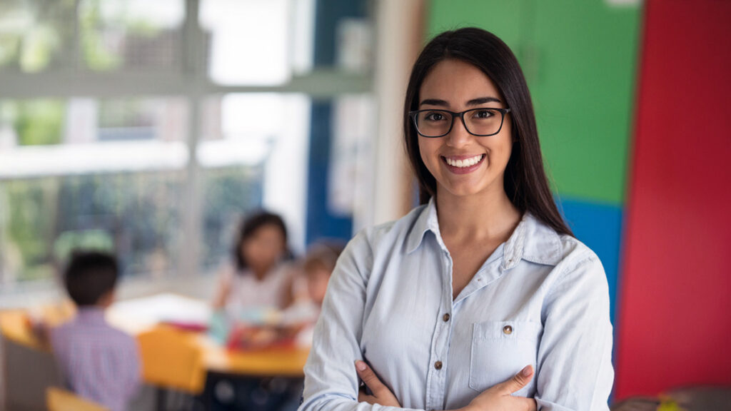 Smiling female classroom teacher with glasses