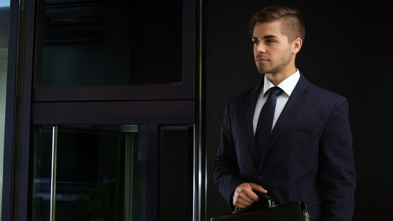 Young business executive holding briefcase