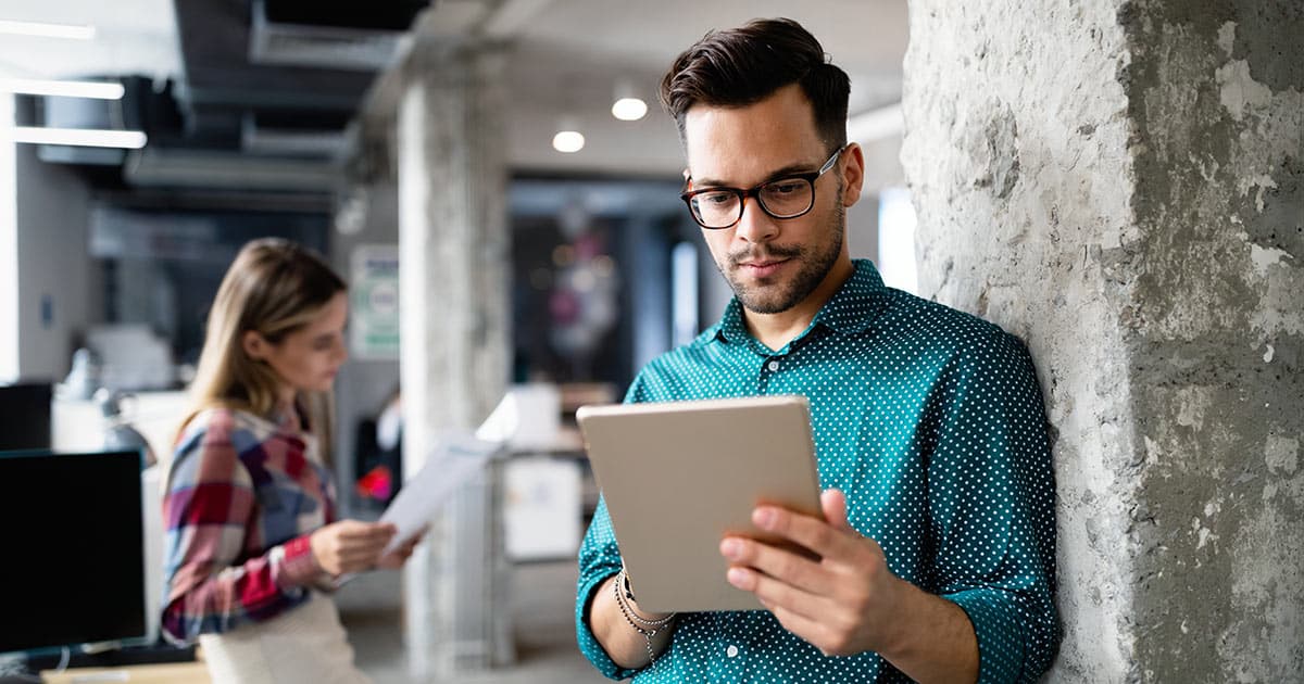 Young man studying computer tablet